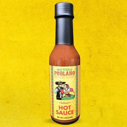 Bottle of Old Pueblo Poblano hot sauce on a yellow background